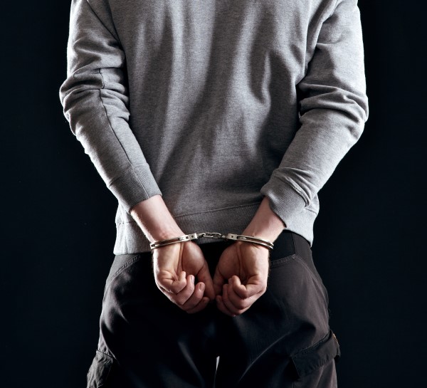 criminal-in-handcuffs-arrested-for-his-crimes-SBI-301327028.jpg